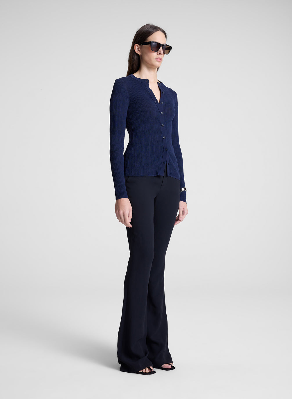 woman wearing navy cardigan and black pants