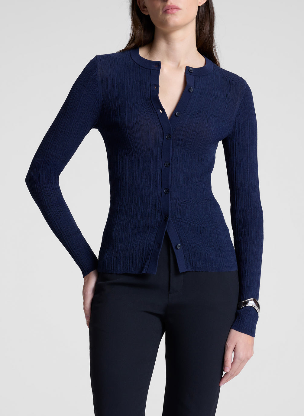 woman wearing navy cardigan and black pants