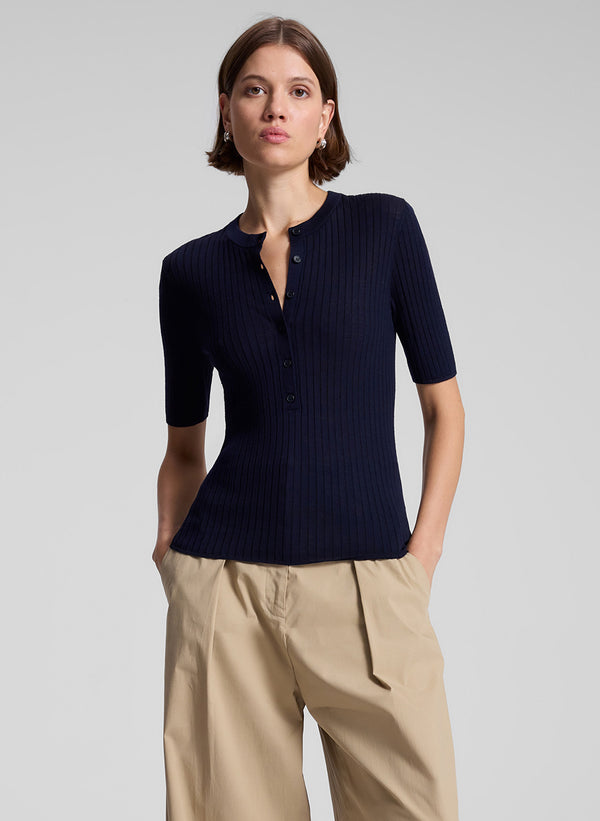 woman wearing navy blue top and tan pants