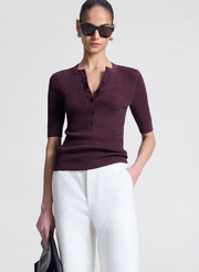 woman wearing purple fine gauge voile knit top and white denim jeans