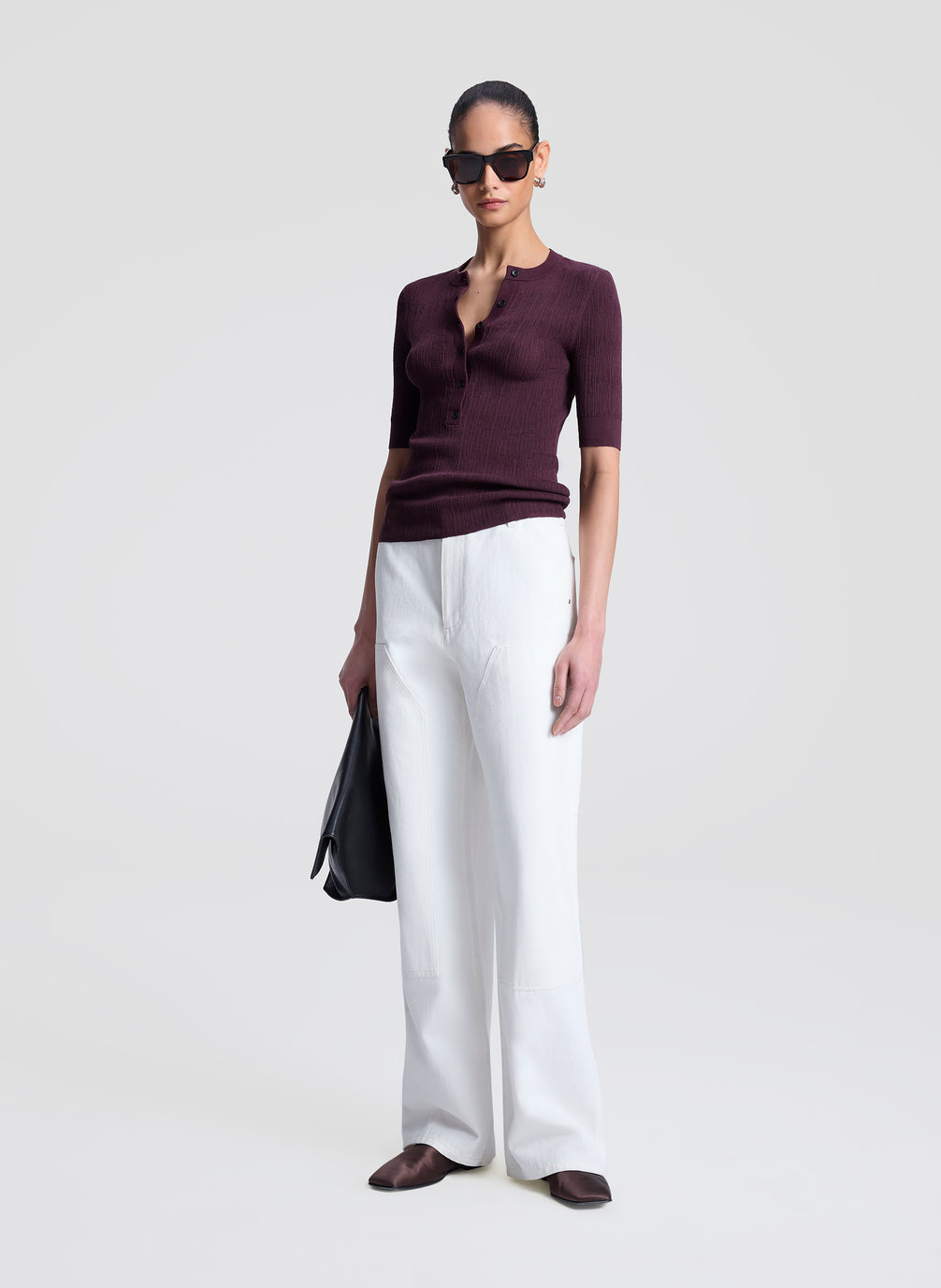 woman wearing purple fine gauge voile knit top and white denim jeans