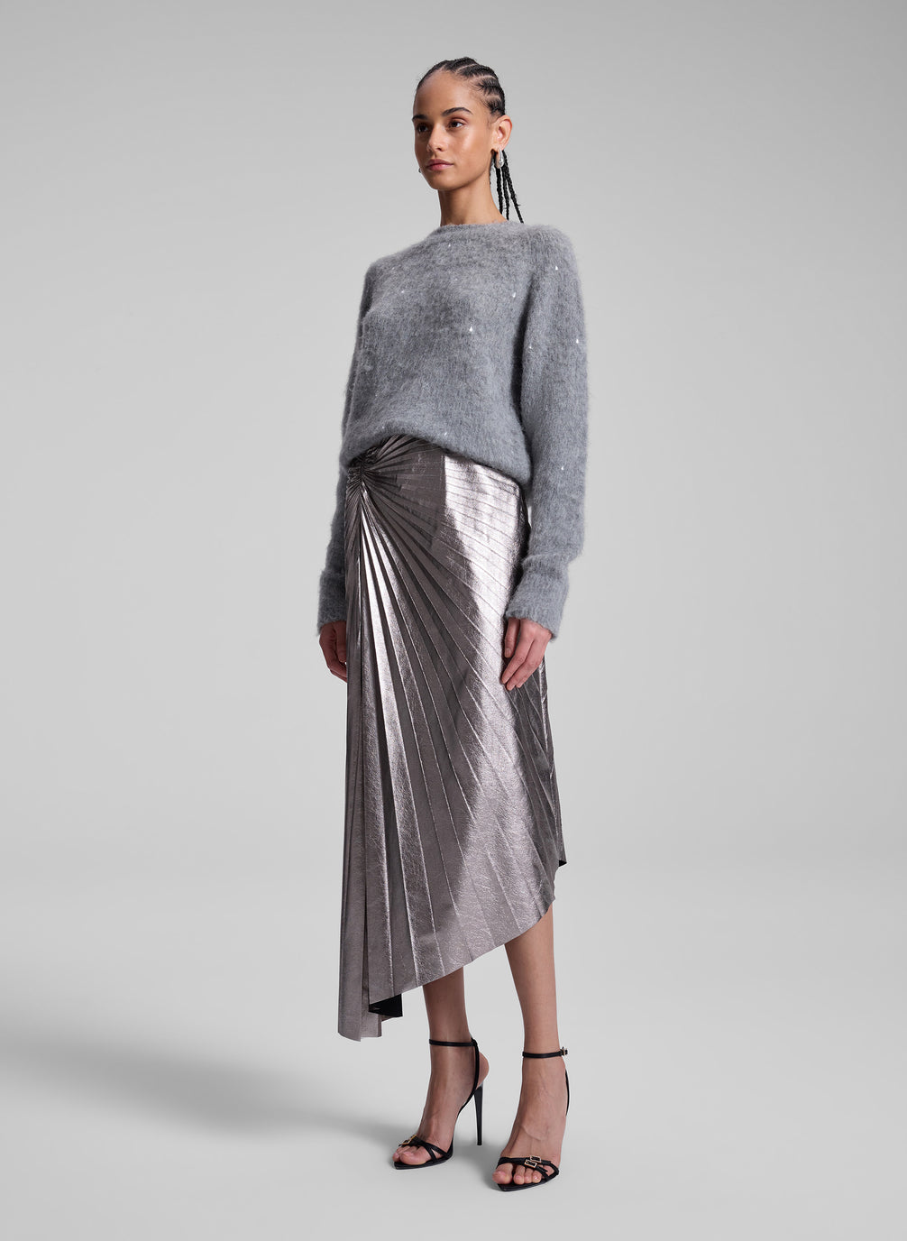 woman wearing grey sweater and silver midi skirt