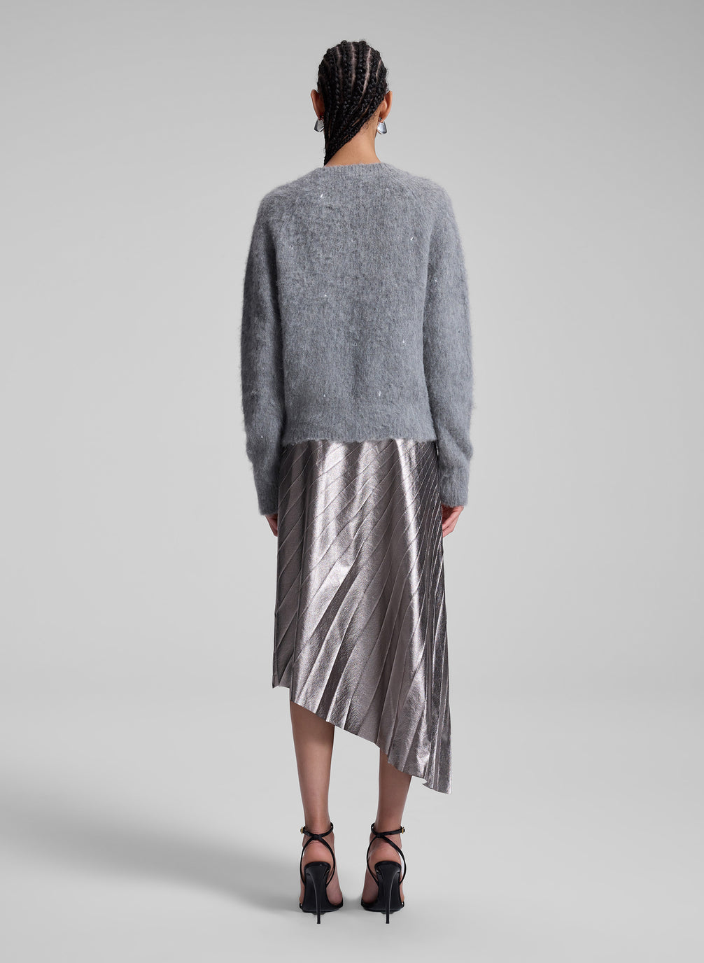 woman wearing grey sweater and silver midi skirt