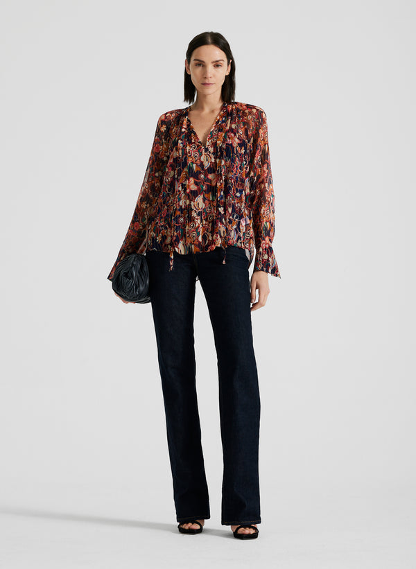 front view of woman wearing silk long sleeve printed blouse and black pants