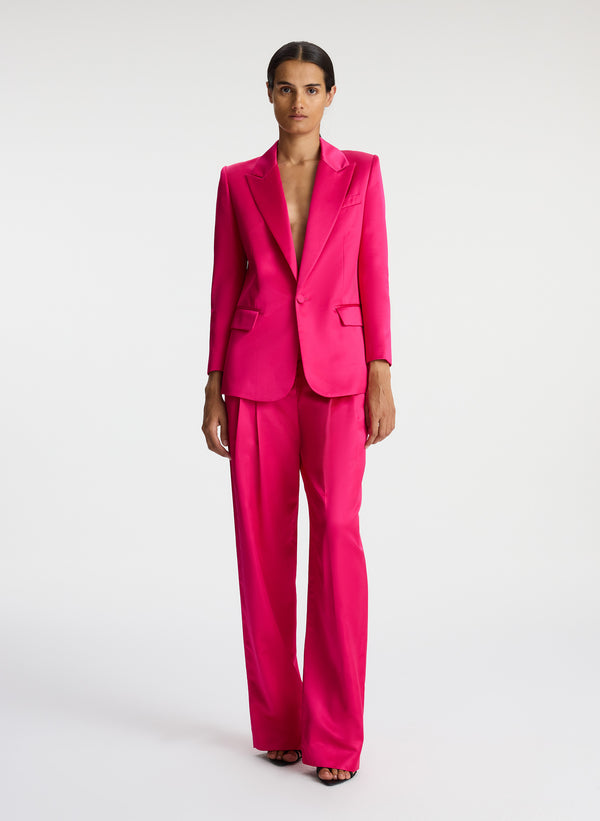 front view of woman wearing bright pink satin blazer with bright pink satin pants