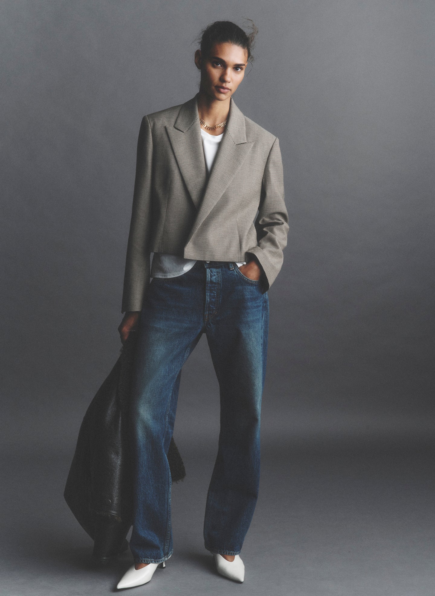 woman wearing tan blazer and jeans