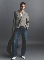 woman wearing tan blazer and jeans