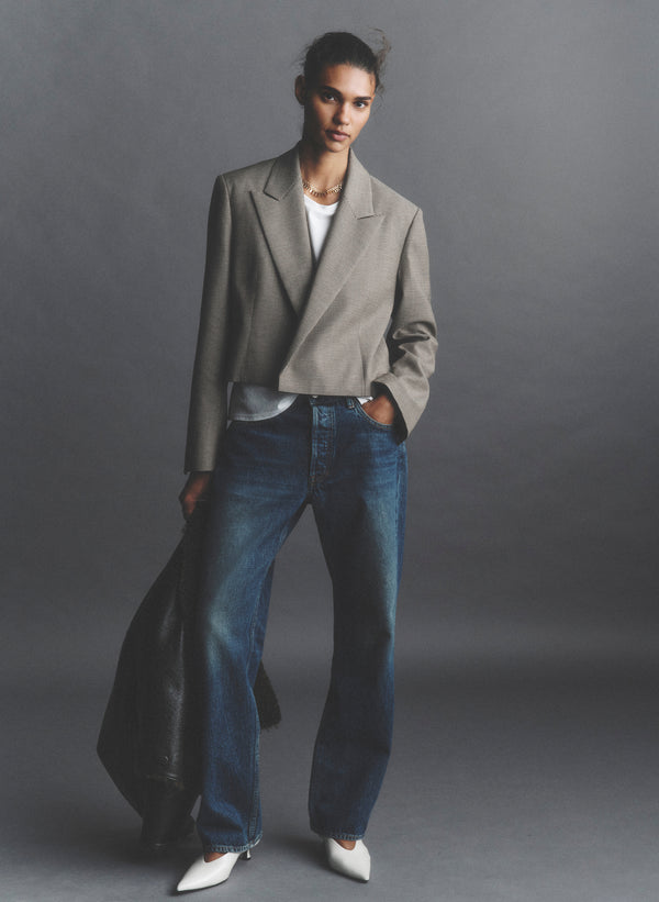 woman wearing tan blazer and jeans