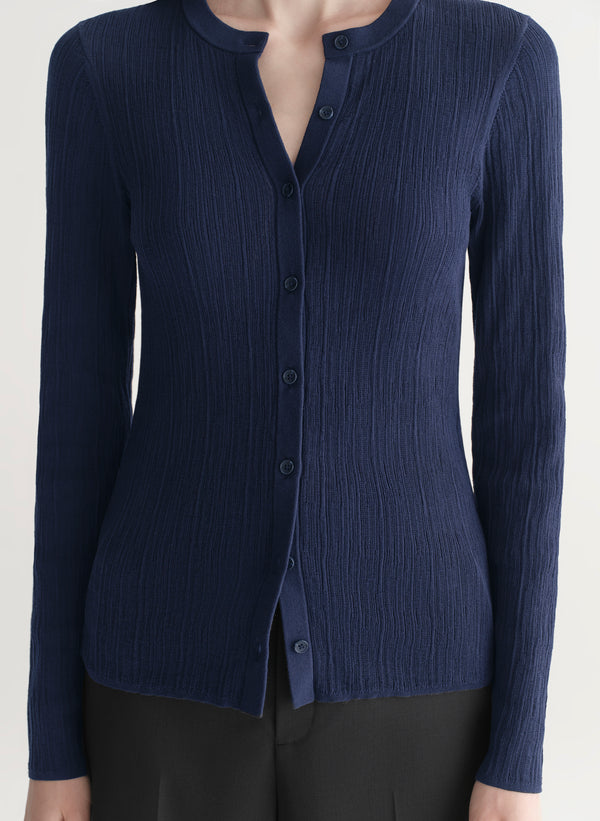 woman wearing navy blue cardigan and black pants