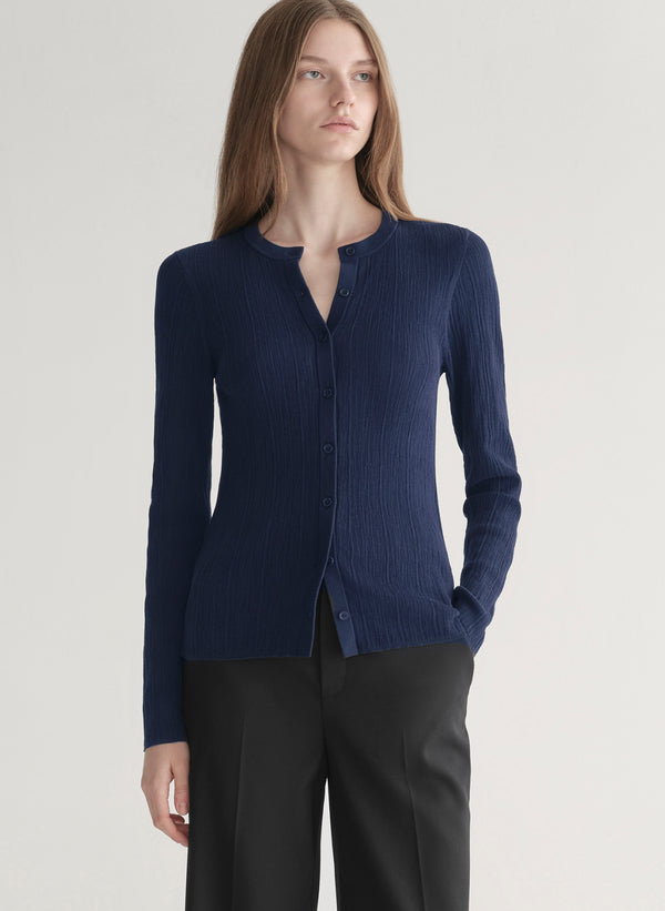 woman wearing navy blue cardigan and black pants