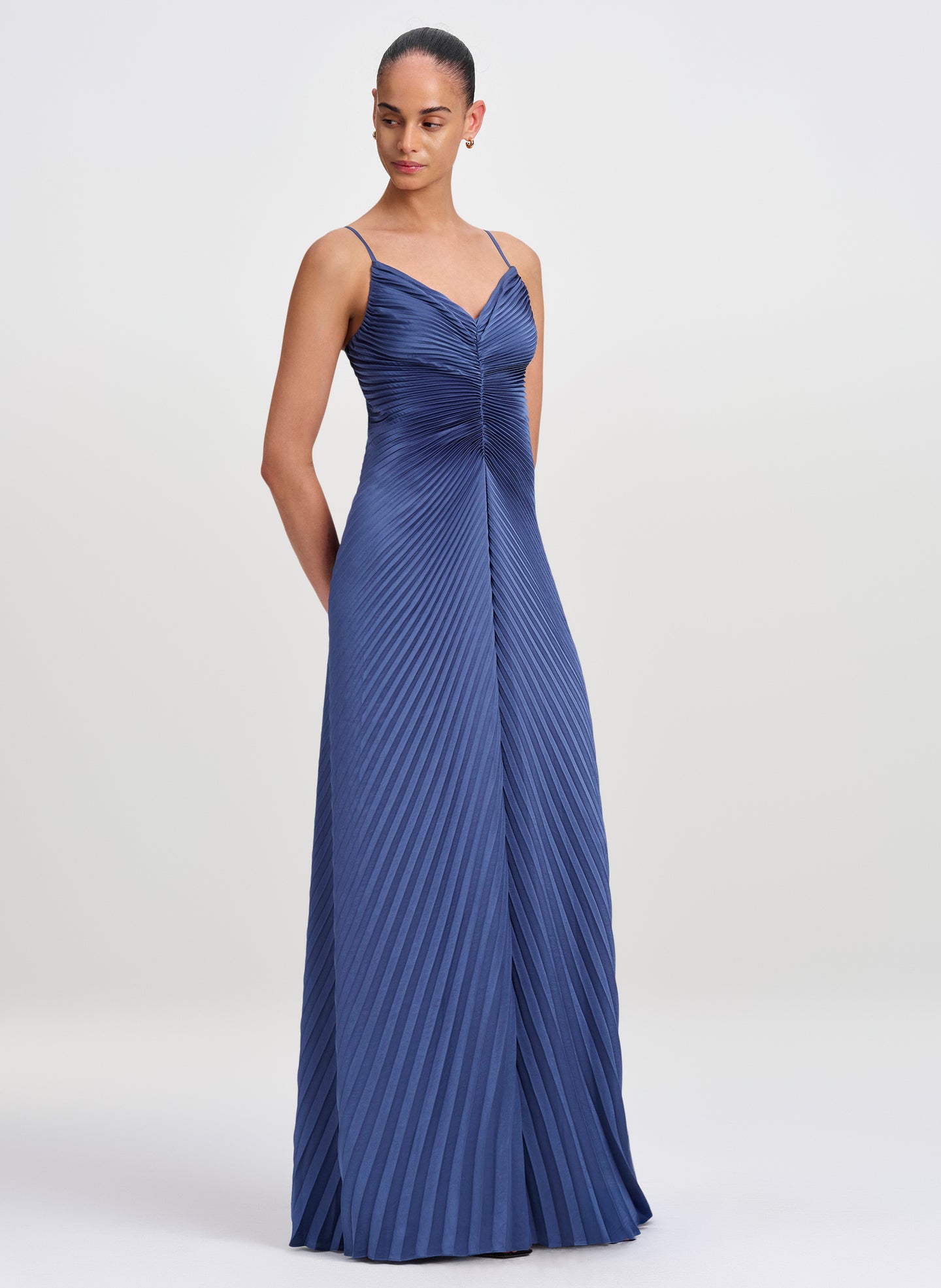 woman wearing blue floor length gown with pleating