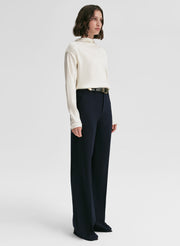 woman wearing white satin top and navy blue pants