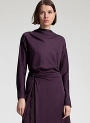 woman wearing purple top and purple midi skirt
