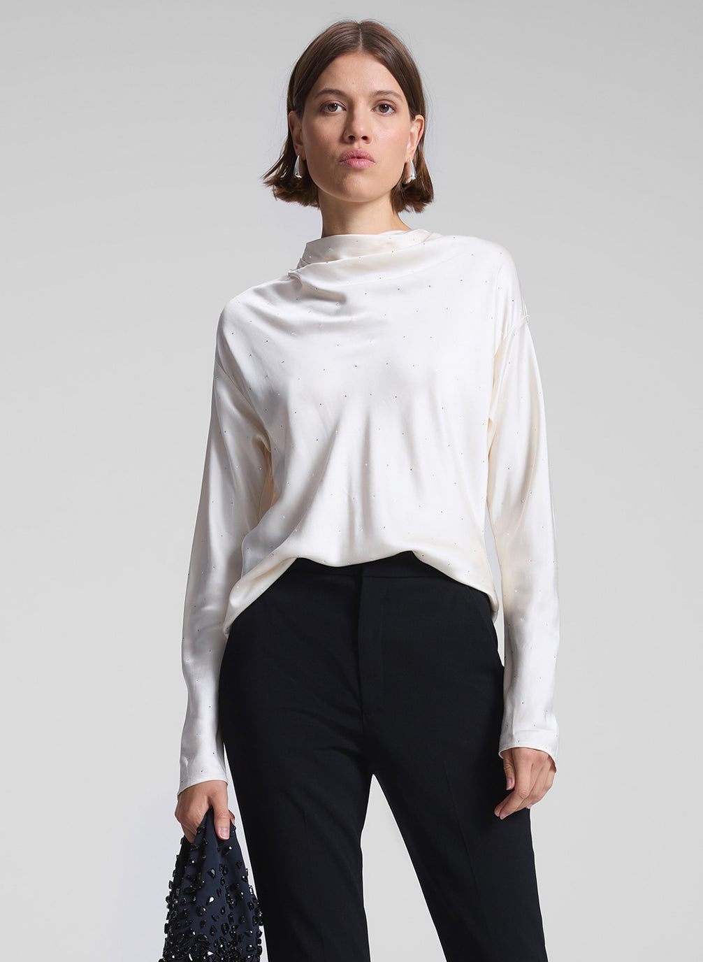 woman wearing white top and black pants