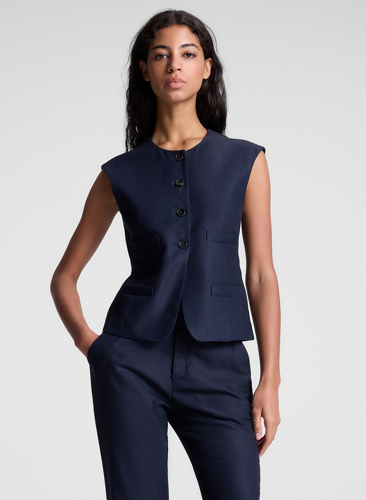 woman wearing navy blue vest and matching pants