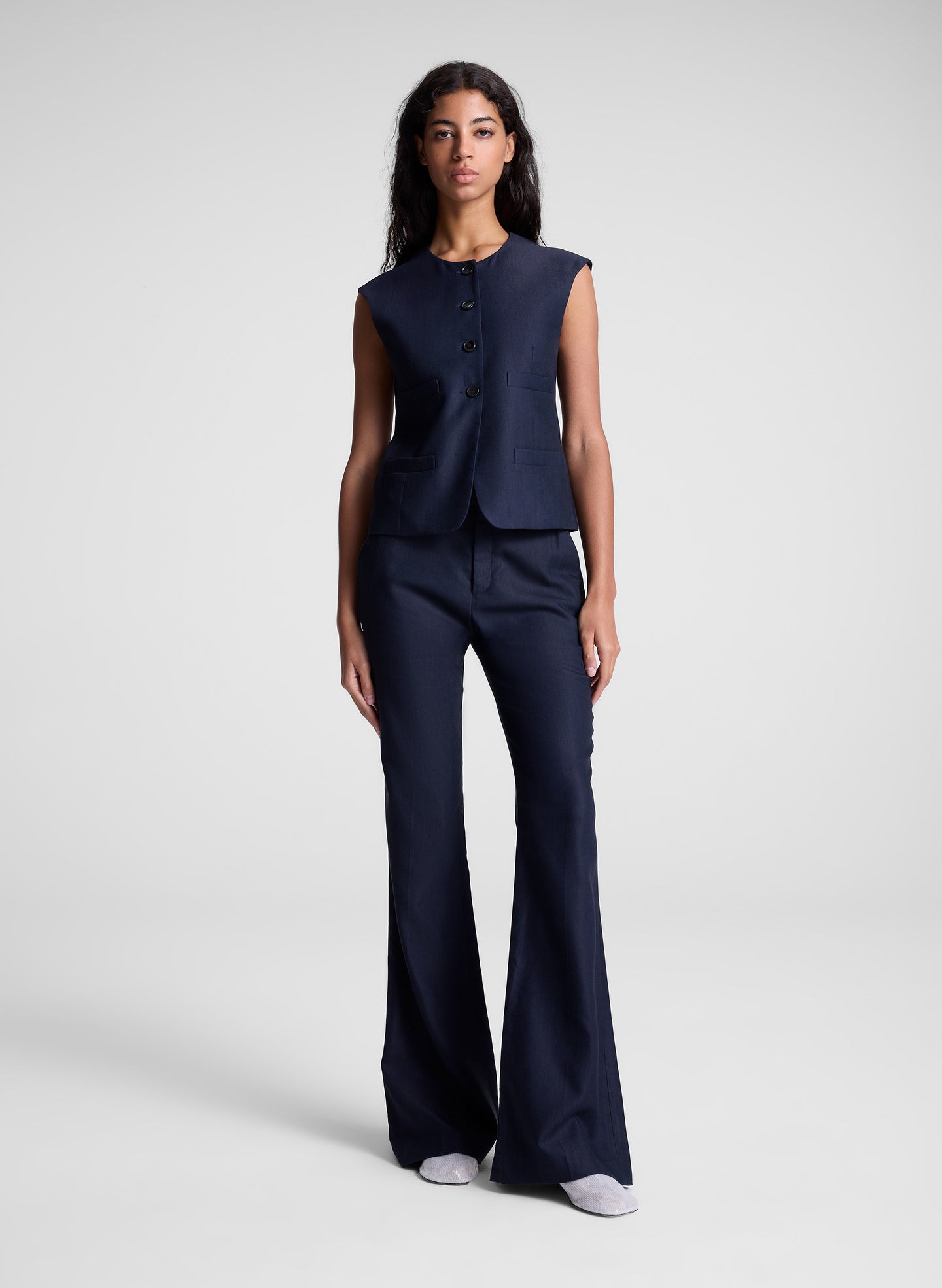 woman wearing navy blue vest and matching pants