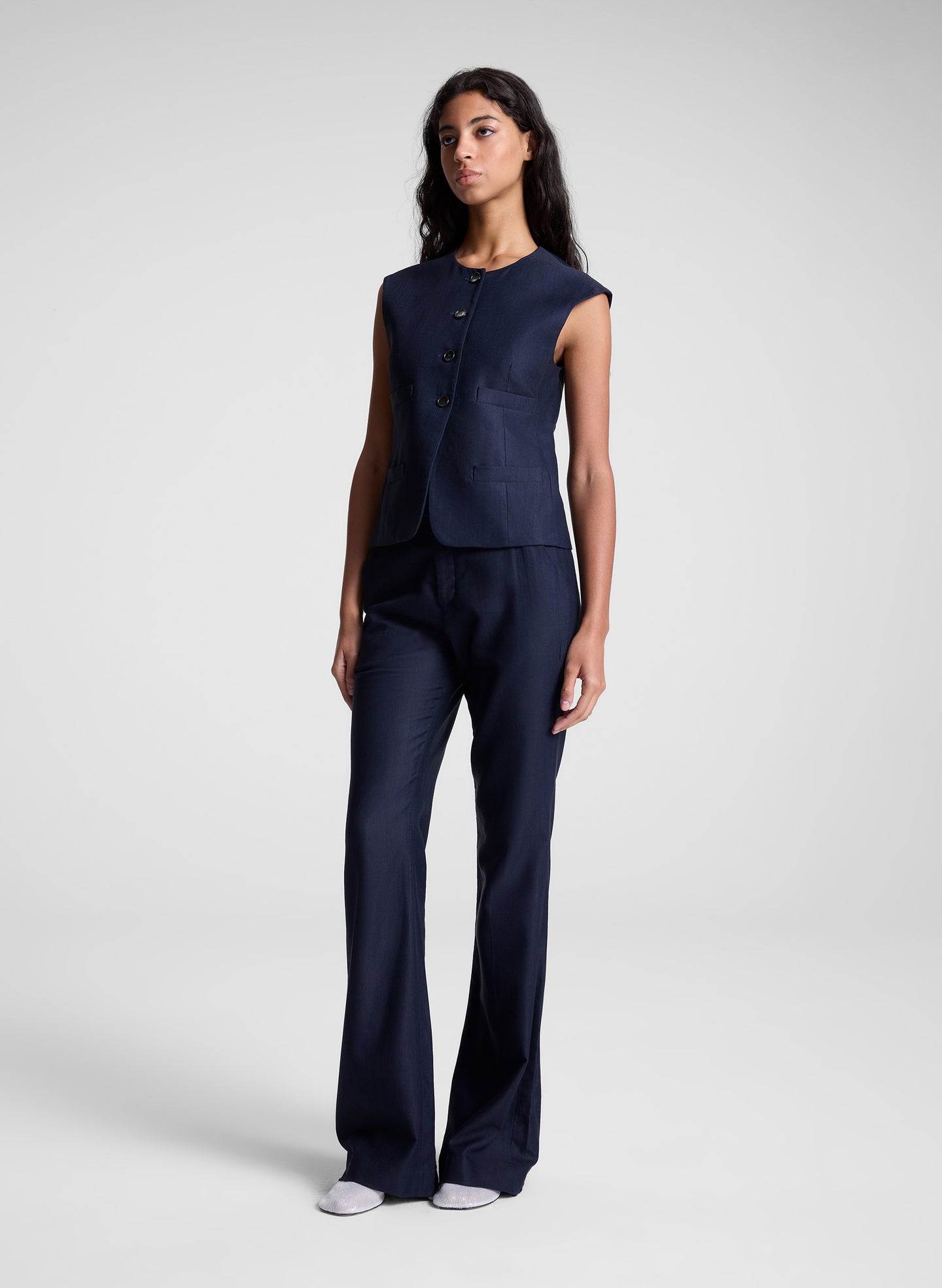 woman wearing navy blue vest and matching pants