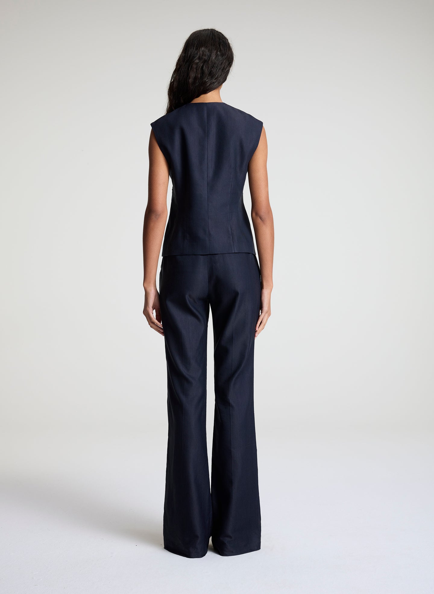 woman wearing navy blue vest suit set