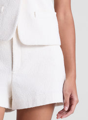 woman wearing white vest and matching shorts