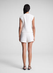 woman wearing white vest and matching shorts