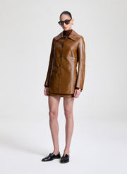 woman wearing brown leather jacket and matching mini skirt