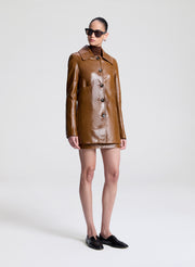 woman wearing brown leather jacket and matching mini skirt