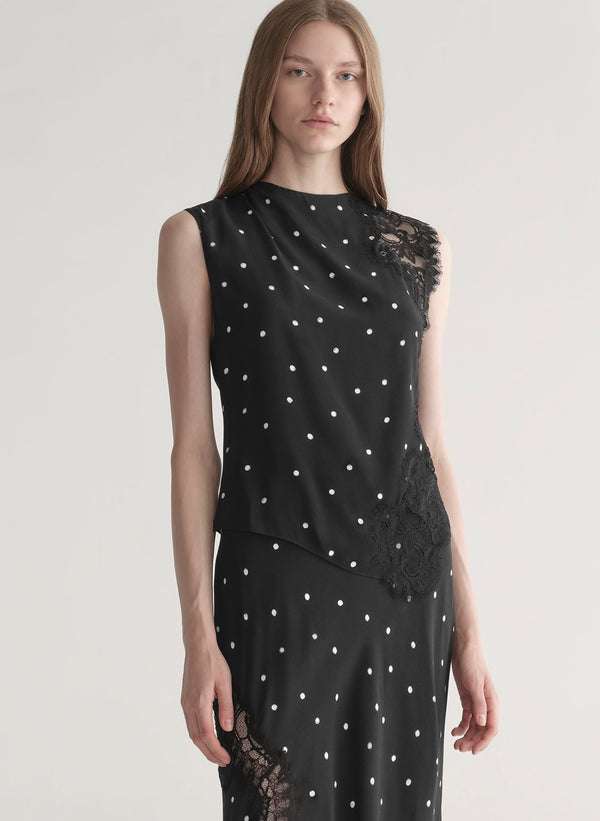 woman wearing black polka dot lace top with matching midi skirt