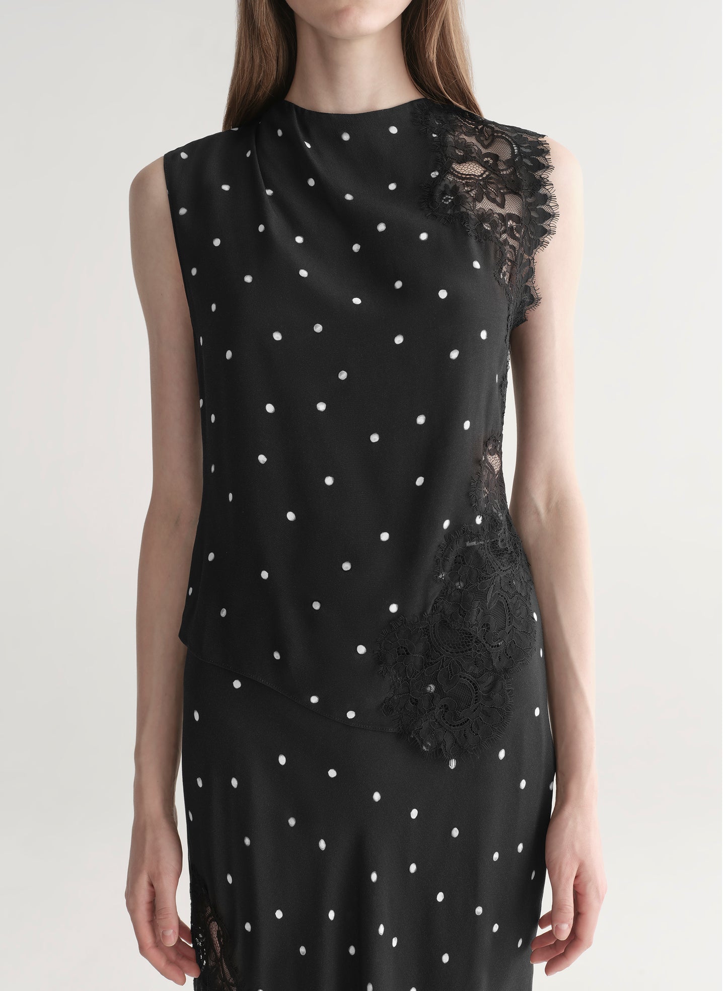 woman wearing black polka dot lace top with matching midi skirt