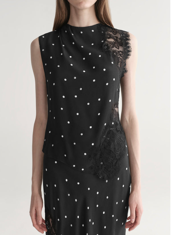 woman wearing black polka dot lace top with matching midi skirt