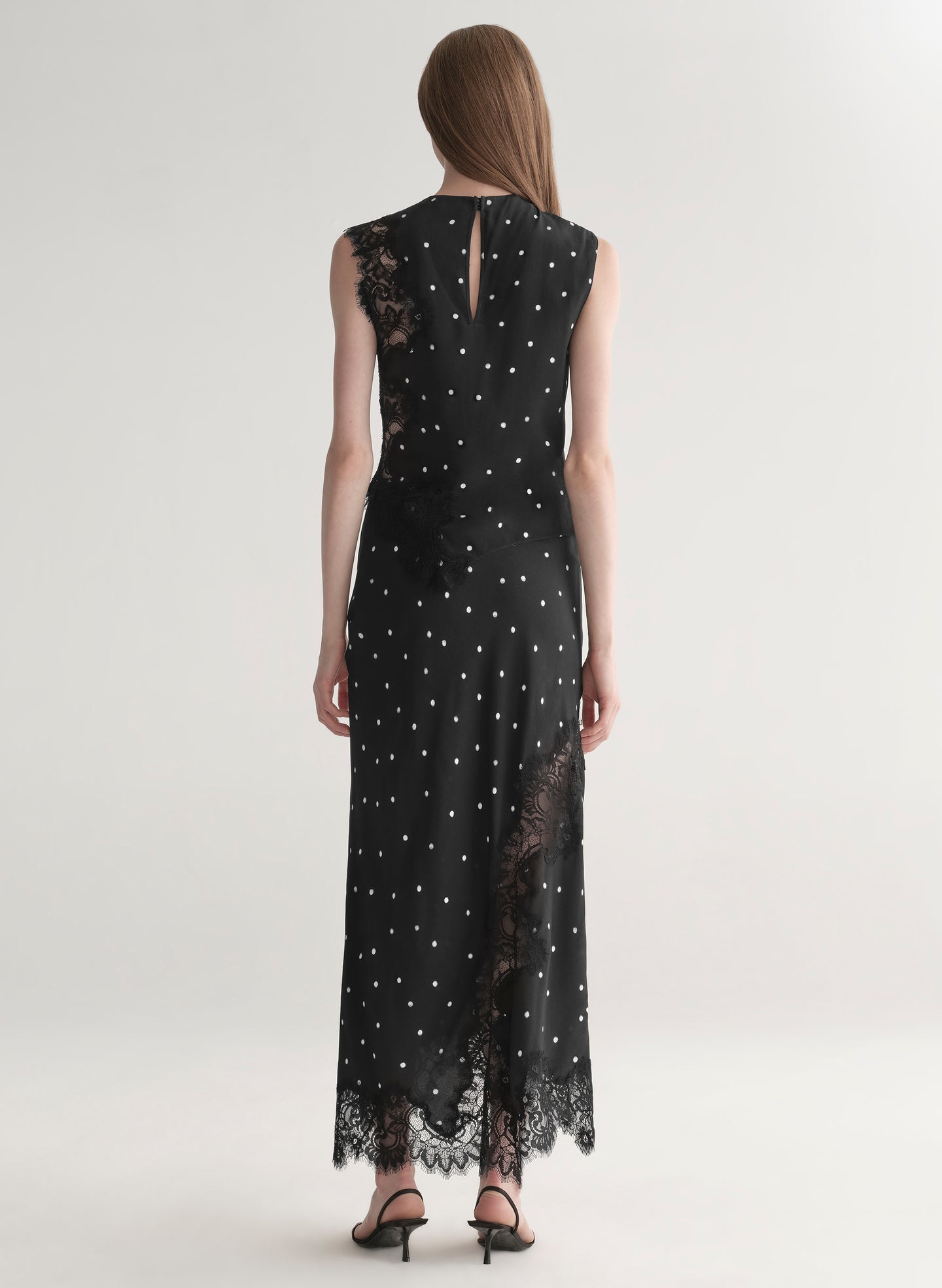 woman wearing black polka dot lace top with matching midi skirt