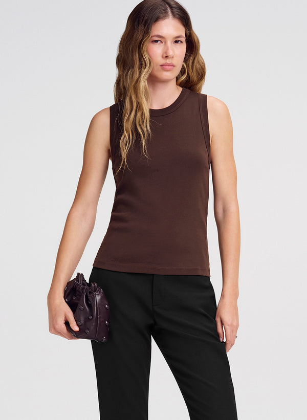woman wearing brown tank top and black pants