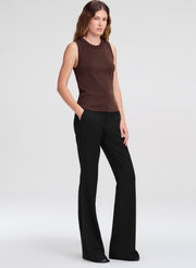 woman in brown tank top and black pants