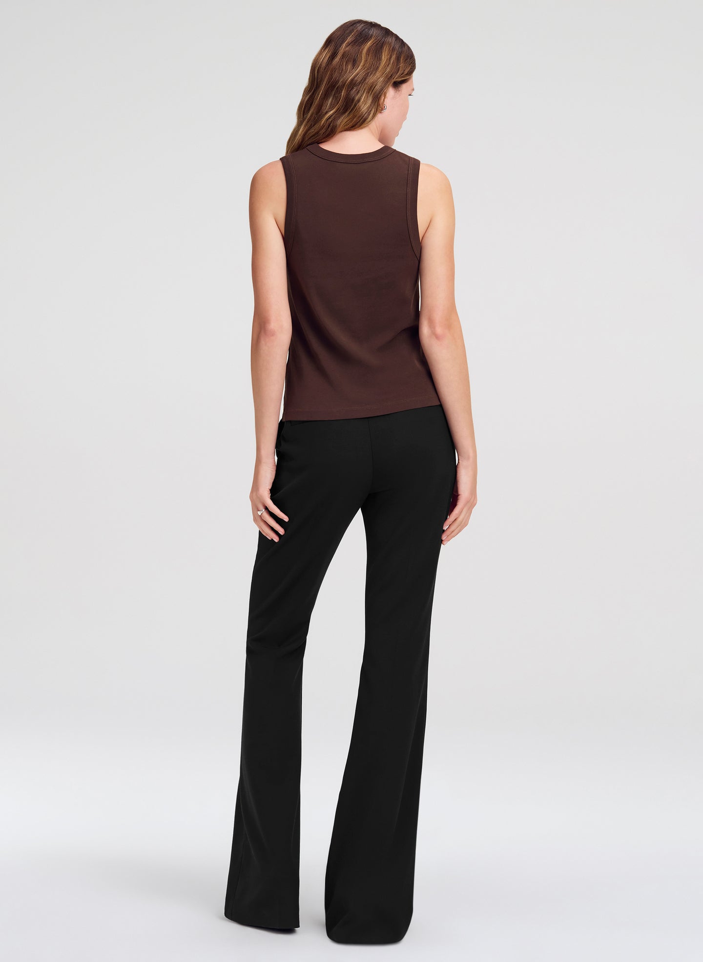 woman wearing brown tank top and black pants