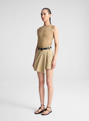 woman wearing beige tank top and beige skort