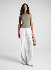 woman carrying tan studded handbag