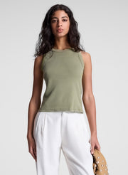 woman wearing green tank top and white pants
