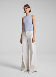 woman wearing grey tank top and white jeans