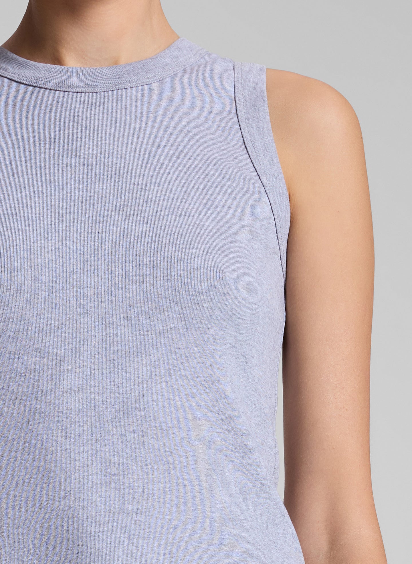 woman wearing grey tank top and white jeans