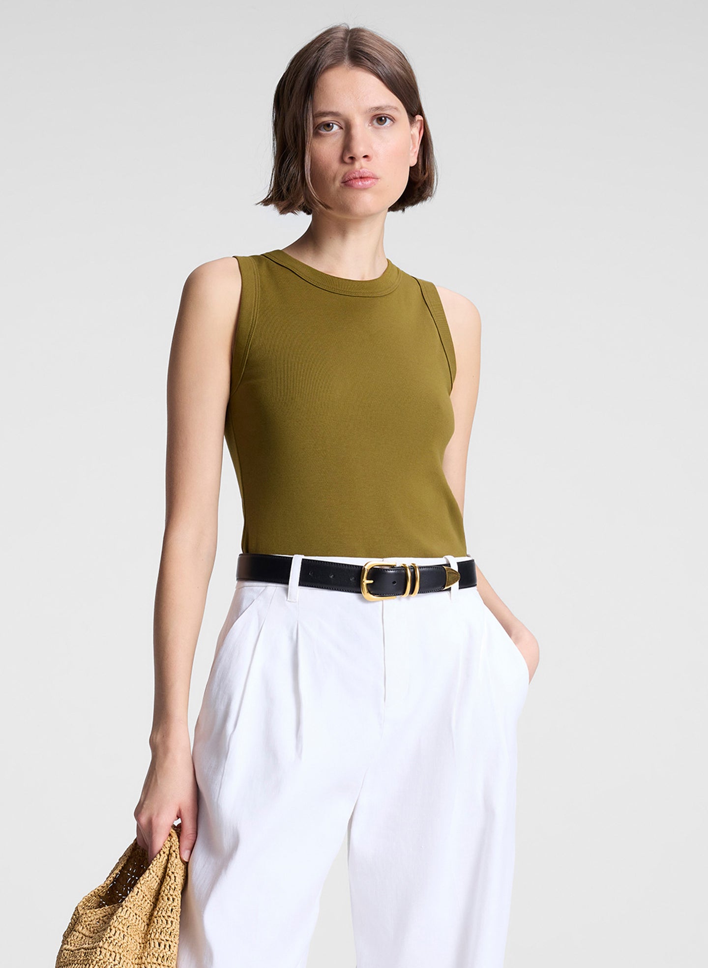 woman wearing white pants and green tank top