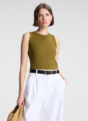 woman wearing white pants and green tank top