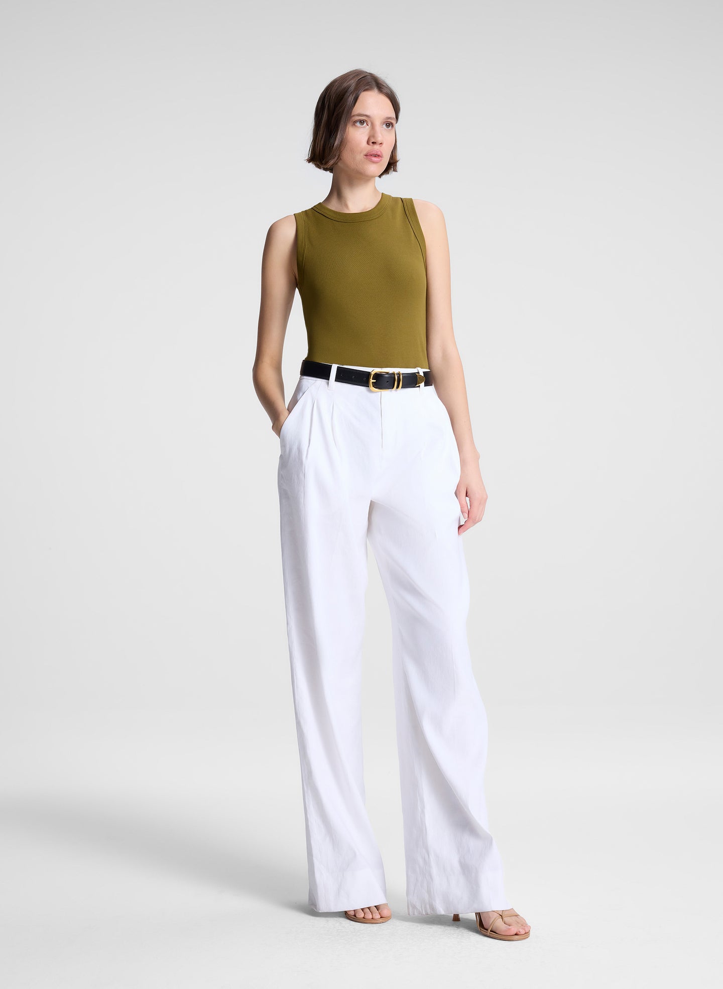 woman wearing white pants and green tank top