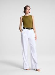 woman wearing white pants and green tank top