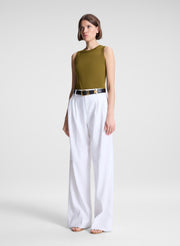 woman wearing white pants and green tank top