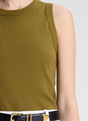 woman wearing white pants and green tank top