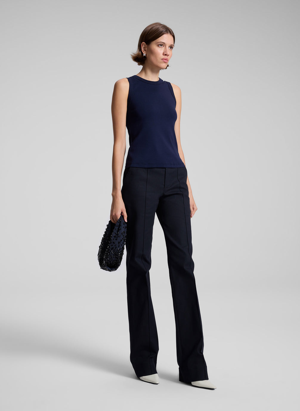 woman wearing navy blue tank top and black pants