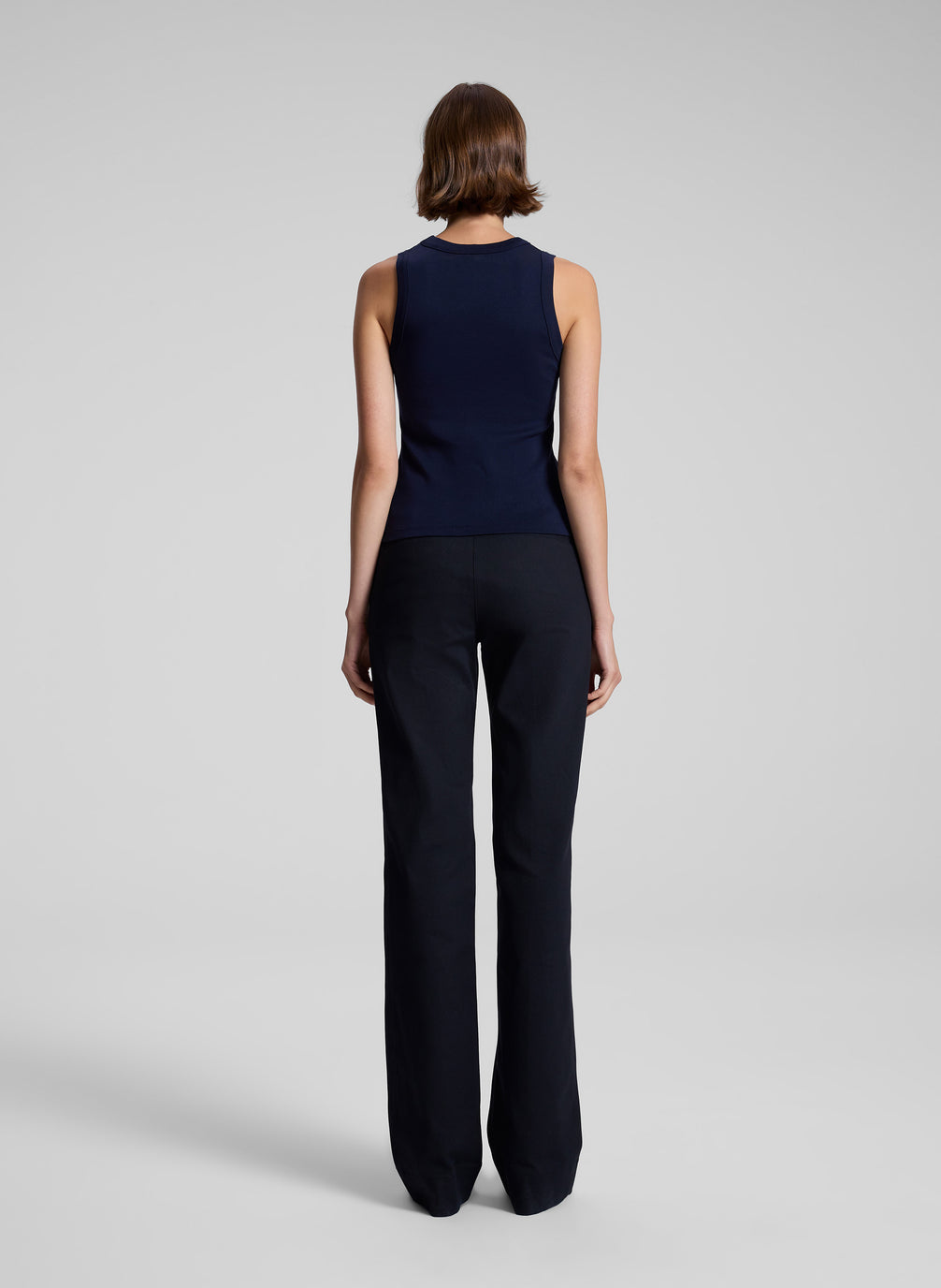 woman wearing navy blue tank top and black pants