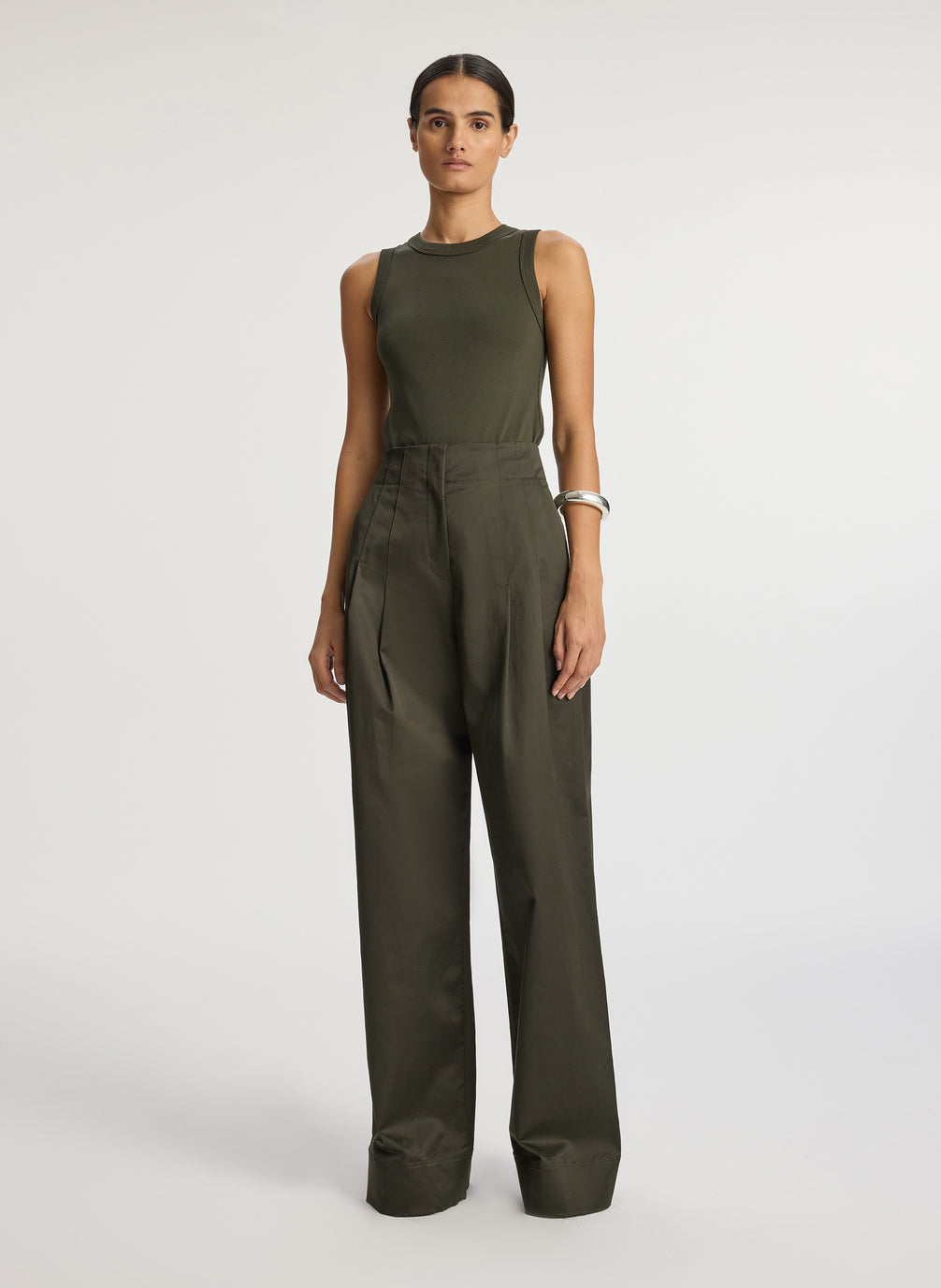 front view of woman wearing olive green tank top and olive green wide leg sateen pants