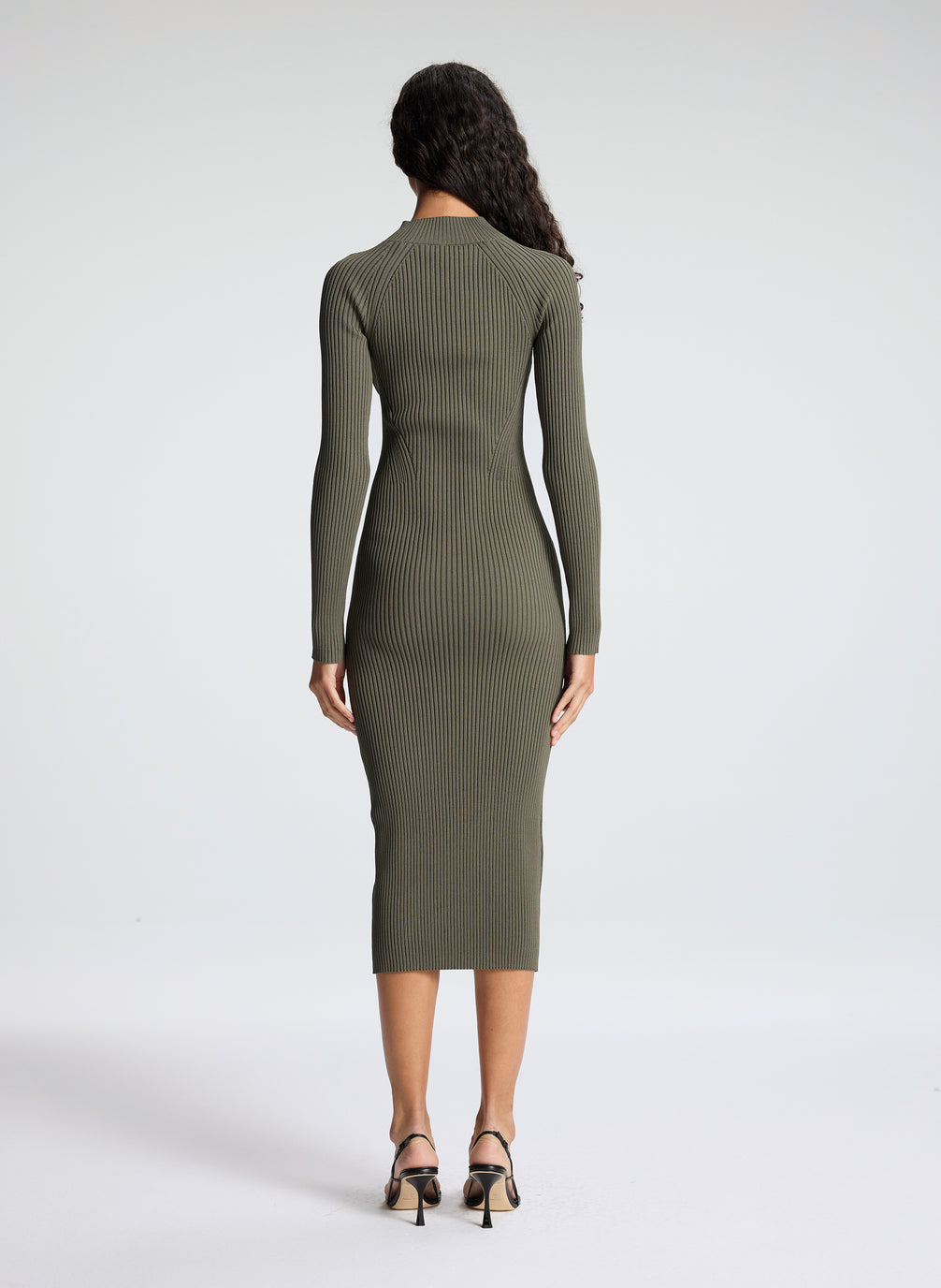 woman wearing green knit midi dress