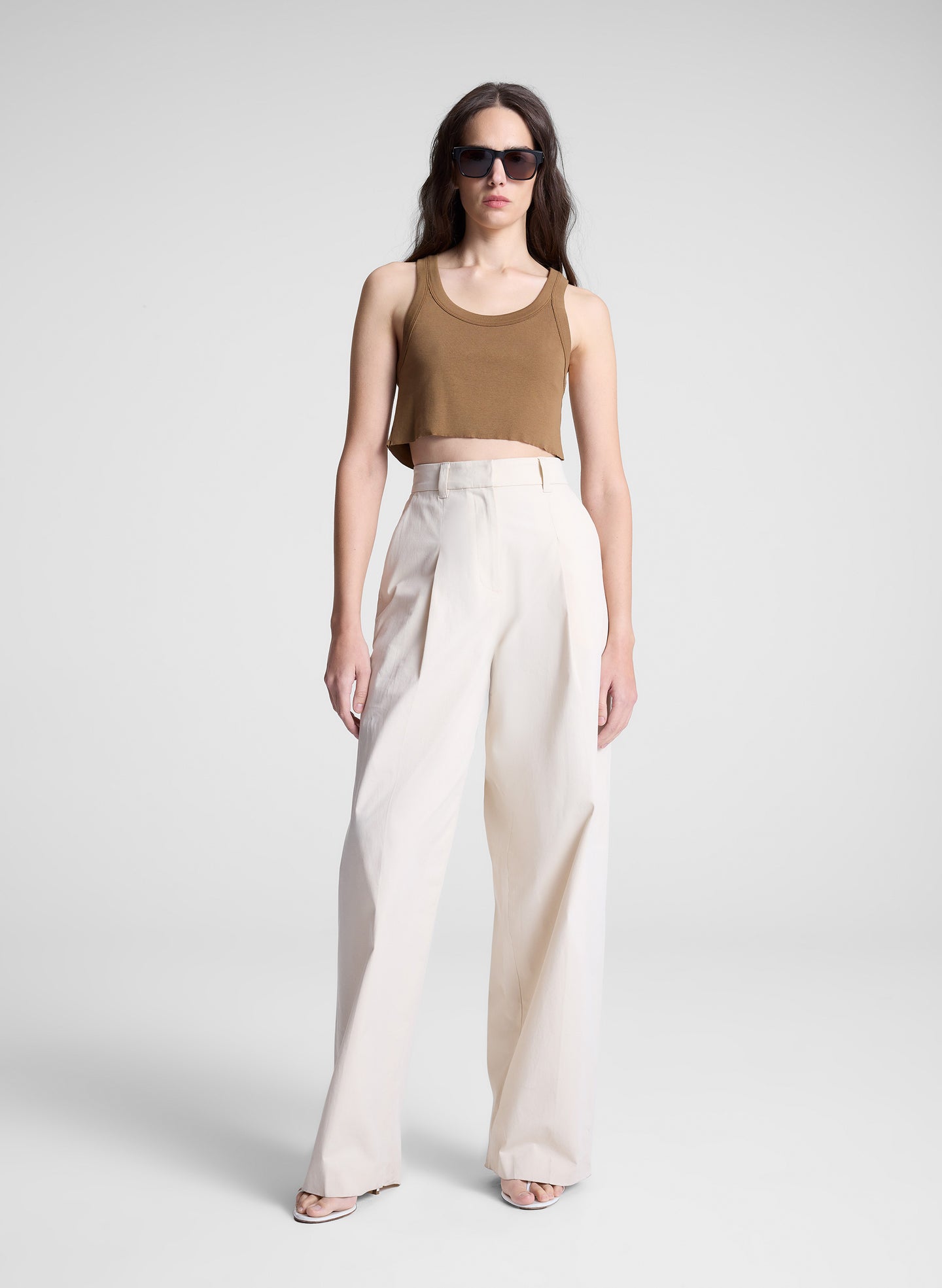 woman wearing brown cropped tank and white pants