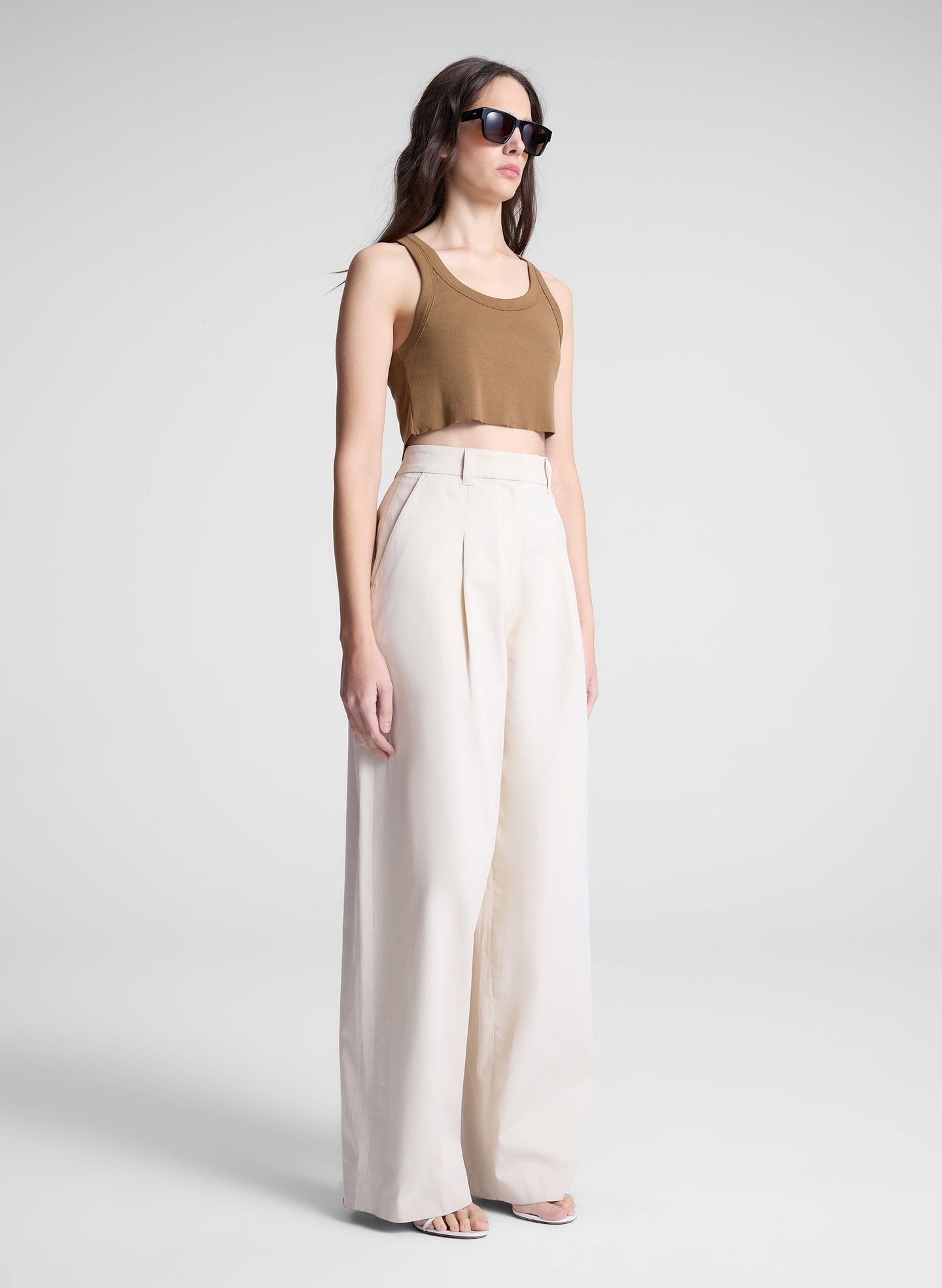 woman wearing brown cropped tank and white pants